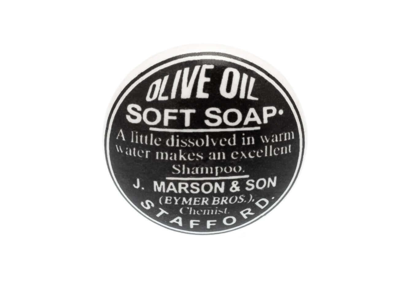Bouton en céramique noir avec écriture de savon doux « Huile d'olive » en blanc 38 mm
